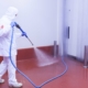 worker cleaning a facility with a power washer