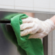 Commercial cleaning company wiping down kitchen bench