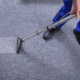 Close Up of Person Cleaning Carpet in Commercial Building
