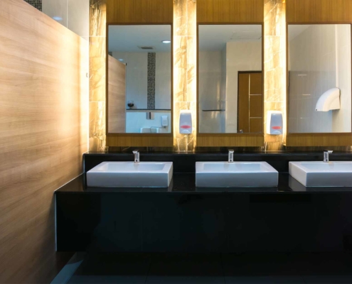 Commercial bathroom with three sinks