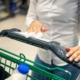 woman wiping a shopping cart