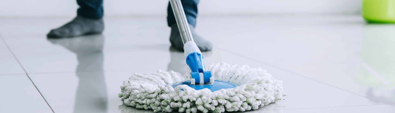 housekeeping and cleaning concept Happy young man in blue rubber gloves