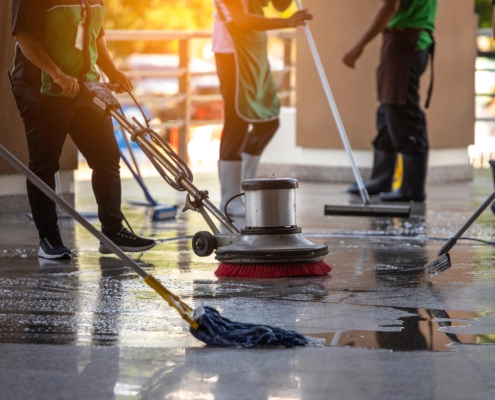 Workers cleaning commercial floor