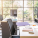 Side view of clean office desks with chairs and computers