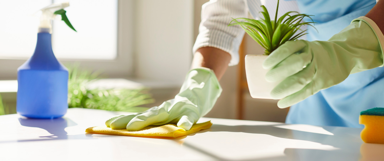 Cleaning worker wiping down a desk top Cleaning Worker Wiping Down A Desk Top