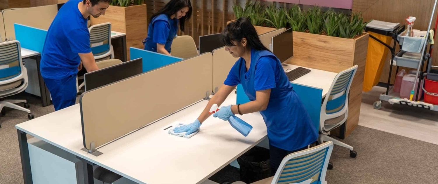 Group of cleaners clean an empty office space