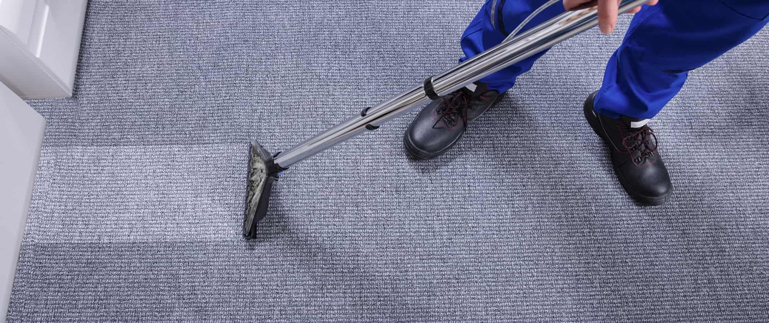 October-Blog-2 Close Up of Person Cleaning Carpet in Commercial Building