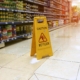 Wet floor sign in aisle of grocery store